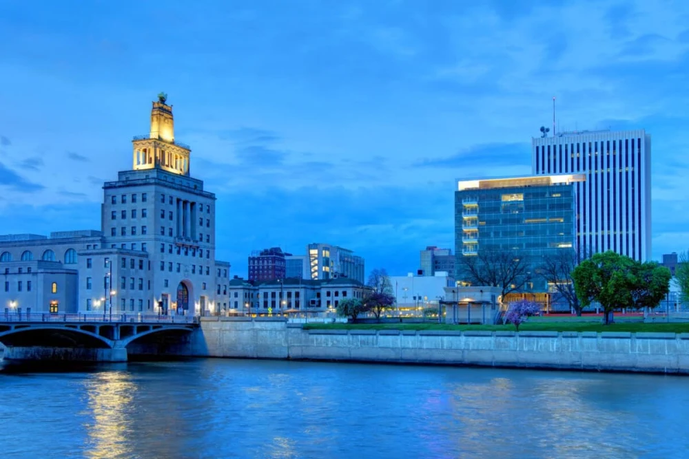 Cedar Rapids Iowa skyline along the Cedar River with downtown buildings at dusk